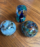 Trio of Dark Blue and Green Glass Paperweights