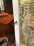 Vintage White Wooden Short Light Up Glass Display Cabinet With Tropical Wallpaper Background
