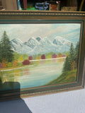 Gold and Green Framed Riverside Painting With Colorful Foliage and Mountains