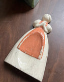 Small Ceramic Pink and White Figurine of Woman in Apron