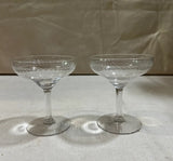 Pair of Champagne Glasses With Etched Designs on Rim