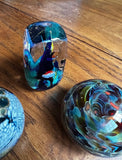 Trio of Dark Blue and Green Glass Paperweights