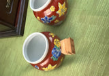 Pair of Red Ceramic Asian Catchalls With Wooden Handles