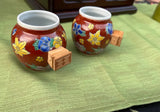 Pair of Red Ceramic Asian Catchalls With Wooden Handles