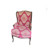 Pink Cushioned Chair With Wooden Accents