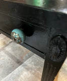 Simple Black Vintage Desk on Wheels With Turquoise and Silver Knobs
