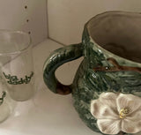 1970s Mid-Century Ceramic Green Pitcher With White Flower Accents