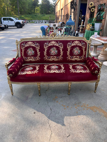 Vintage red and gold embroidered sofa with pillows