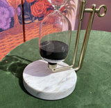 Brass Hourglass on a Marble Slab