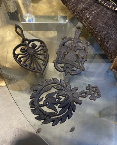 1970s Set of Cast Iron Trivets With Different Designs