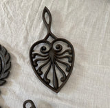1970s Set of Cast Iron Trivets With Different Designs