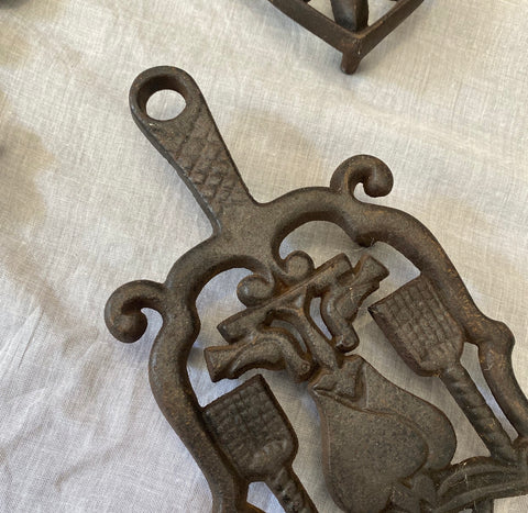 A Small Collection of Cast Iron Trivets 